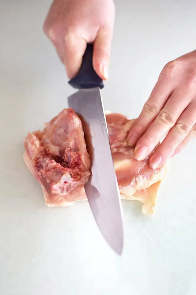 chicken thigh being deboned