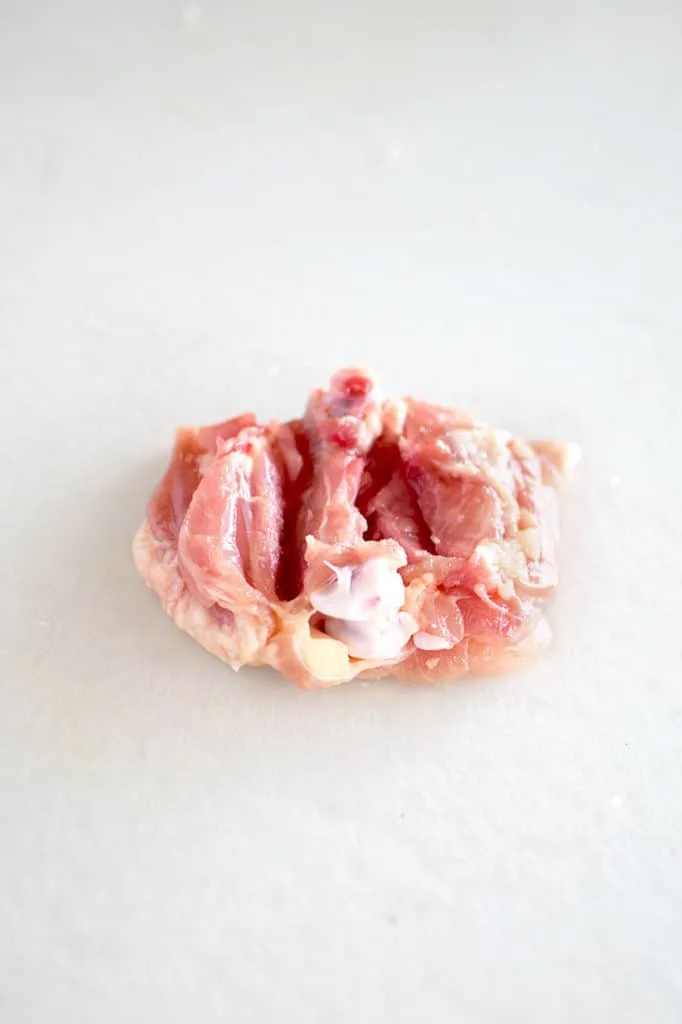 chicken thigh with bone exposed