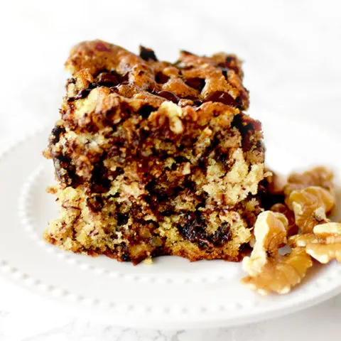 chocolate chip banana cake with nuts on a white plate