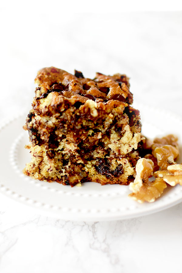 chocolate chip banana cake with nuts on a white plate