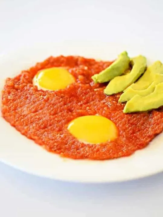 Huevos Rancheros with a side of avocado