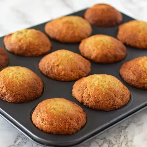 Banana muffins in a pan on a marble counter