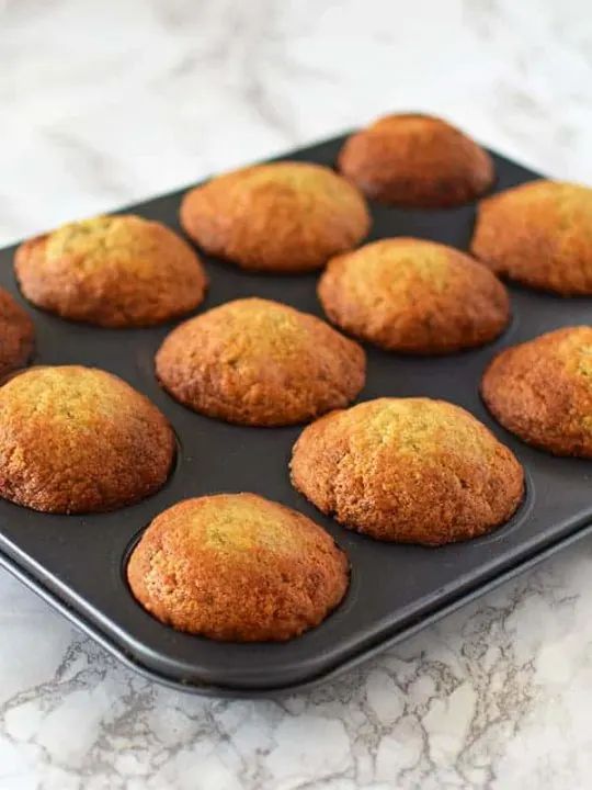 Banana muffins in a pan on a marble counter