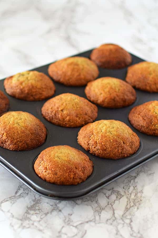 Banana muffins in a pan on a marble counter