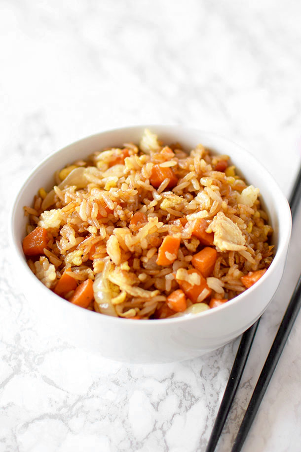 fried rice in a white bowl on a white marble counter