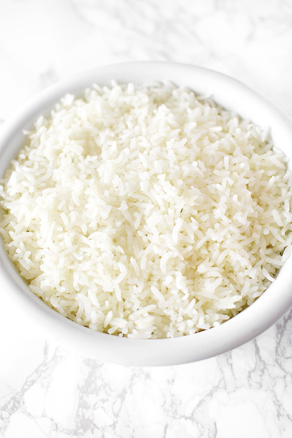 white rice in a white bowl on a marble counter