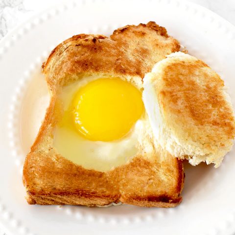 Challah egg in a hole on a white plate