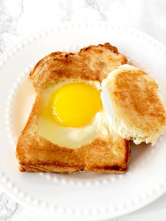 Challah egg in a hole on a white plate