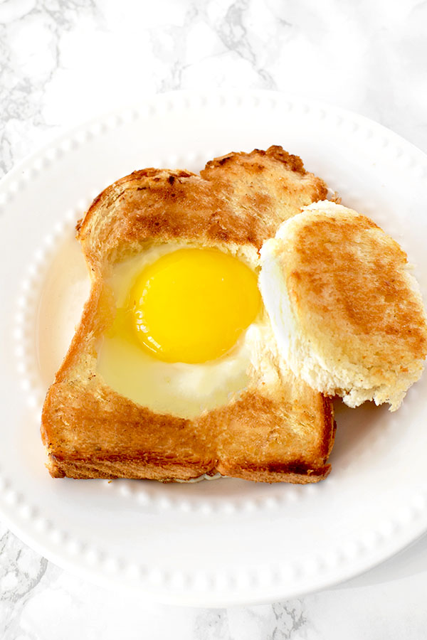 Challah egg in a hole on a white plate