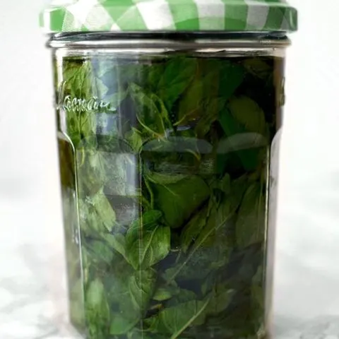 mint extract in a glass jar with a green lid