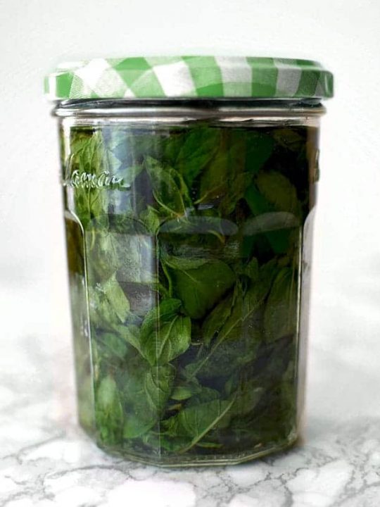 mint extract in a glass jar with a green lid
