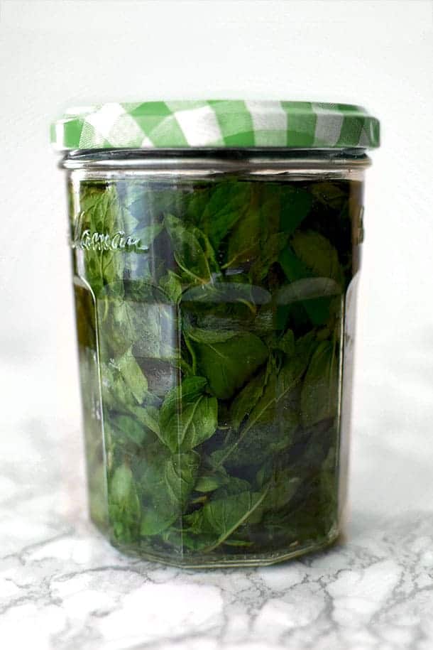mint extract in a glass jar with a green lid