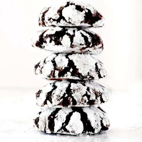 five chocolate crinkle cookies stacked