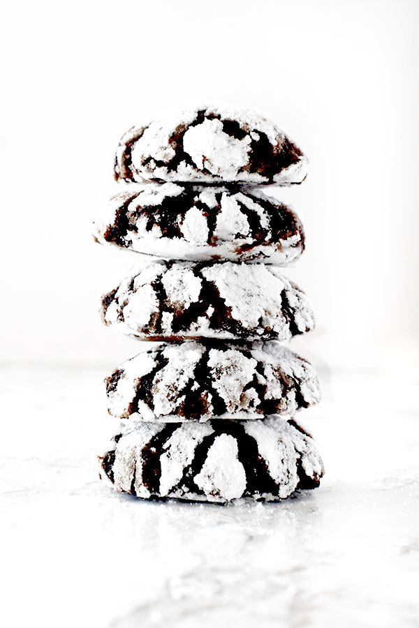 five chocolate crinkle cookies stacked