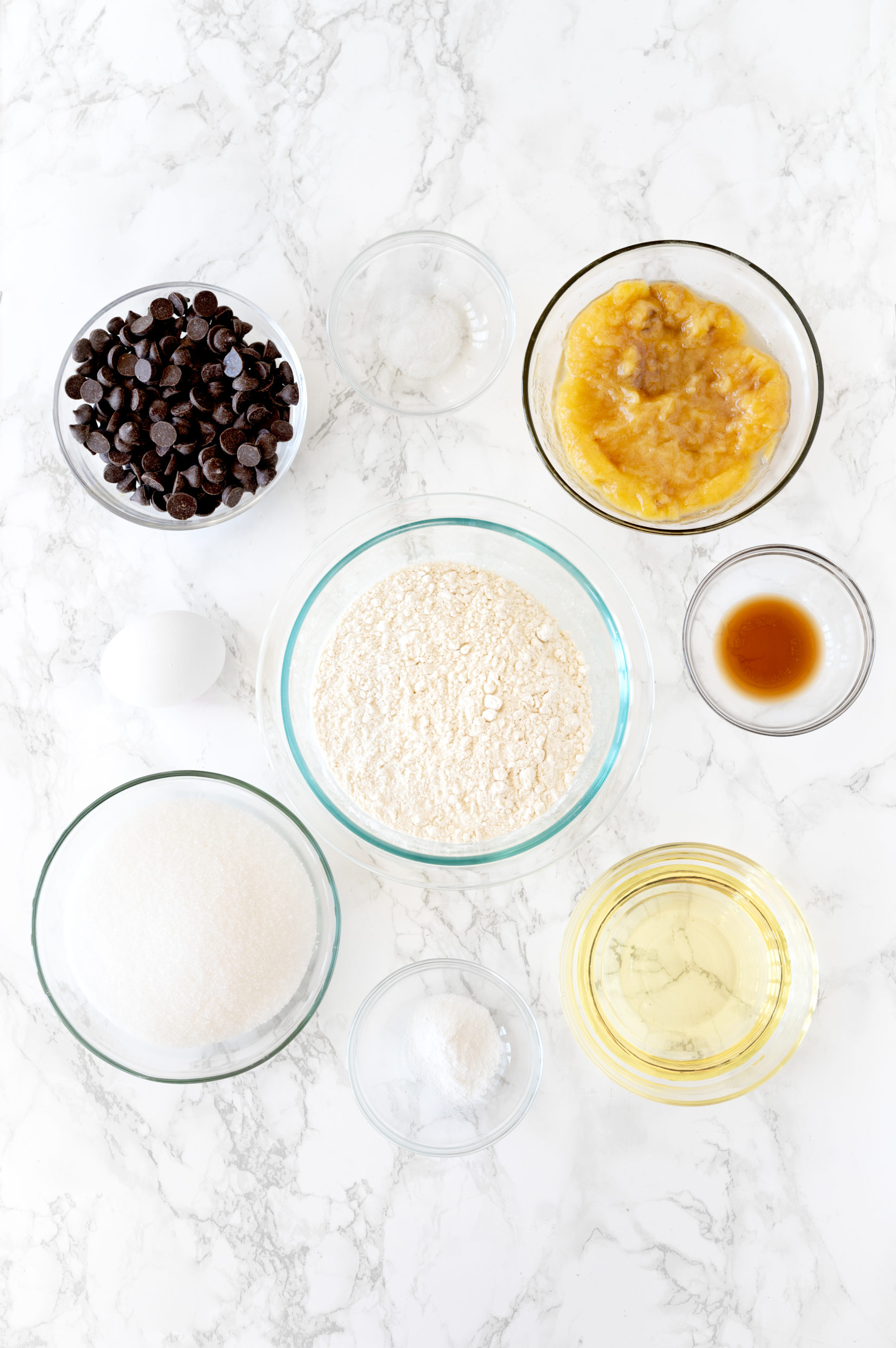 ingredients for in small bowls on a white marble counter