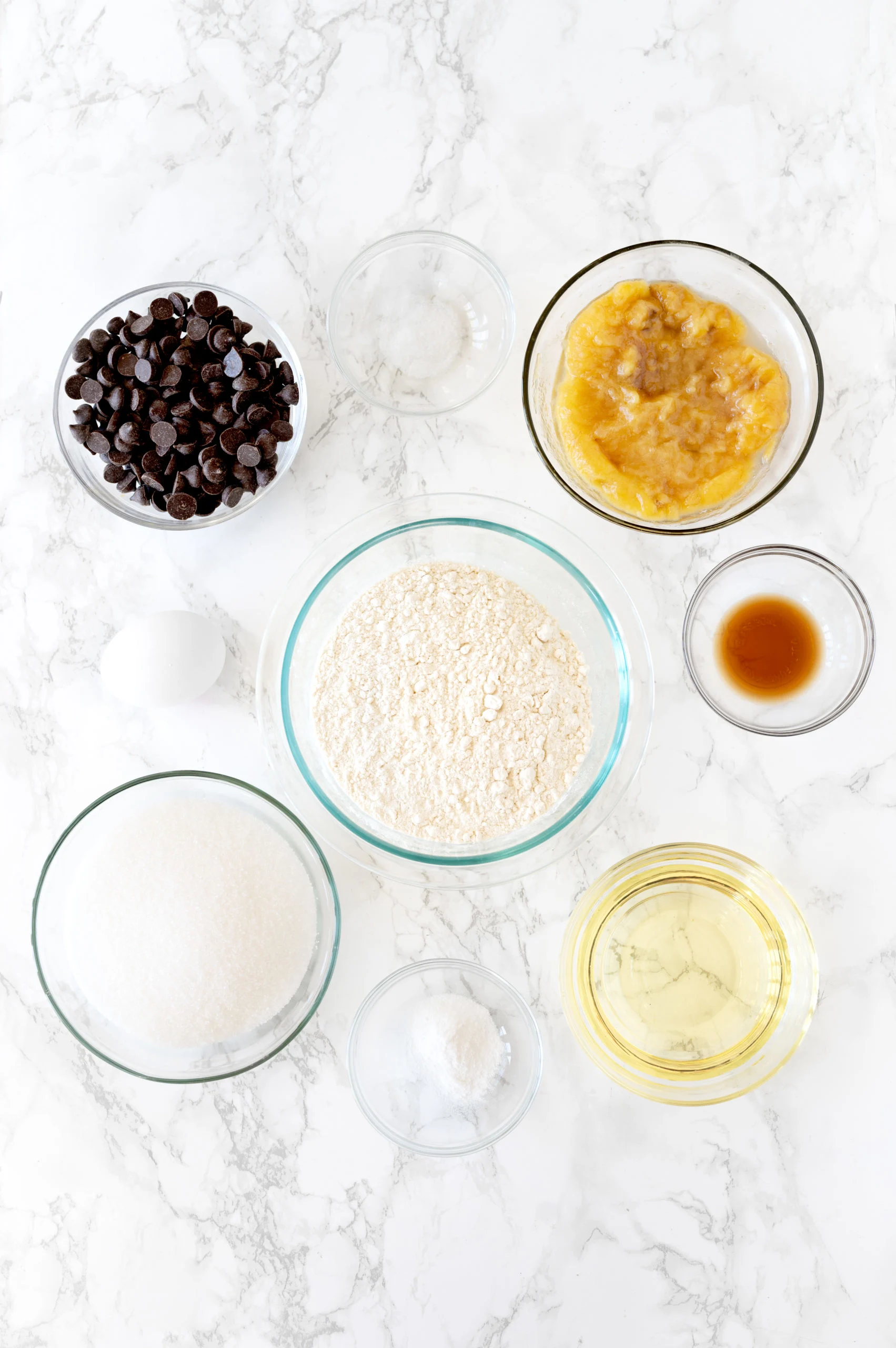 ingredients for in small bowls on a white marble counter