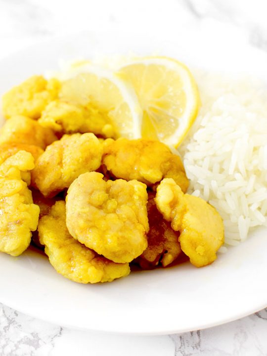 Chinese lemon chicken on a plate with rice