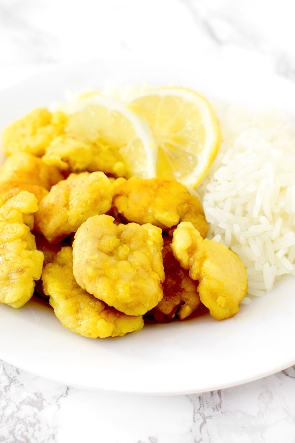 Chinese lemon chicken on a plate with rice