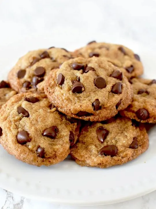 a pile of chocolate chip cookies on a plate
