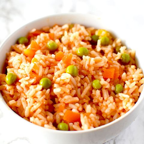 Authentic Mexican rice in a white bowl on a white marble counter