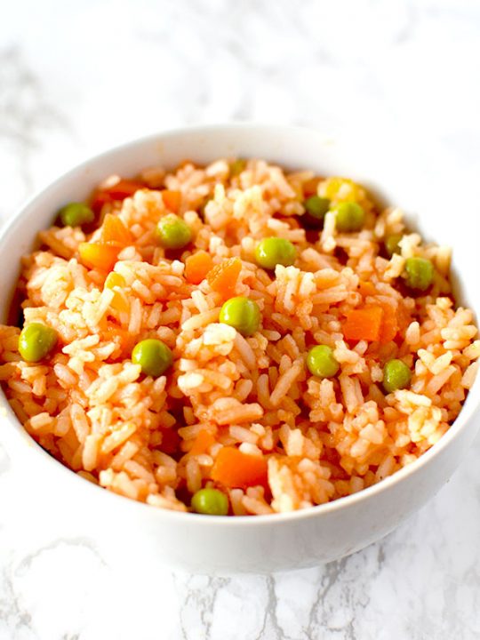 Authentic Mexican rice in a white bowl on a white marble counter