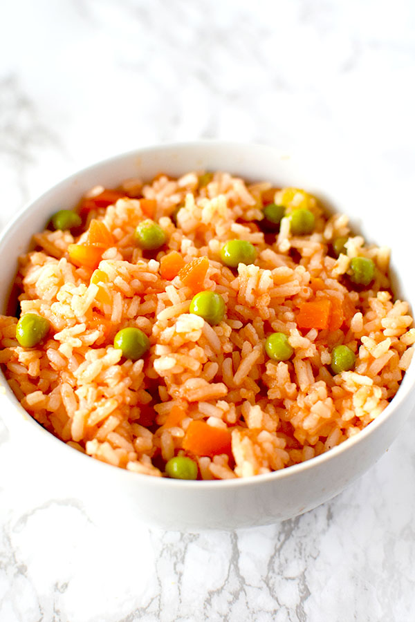 Authentic Mexican rice in a white bowl on a white marble counter