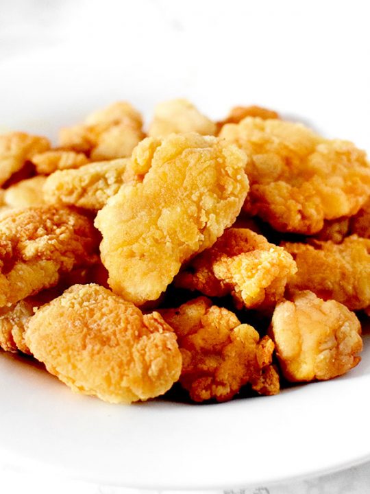 Popcorn chicken piled up on a plate