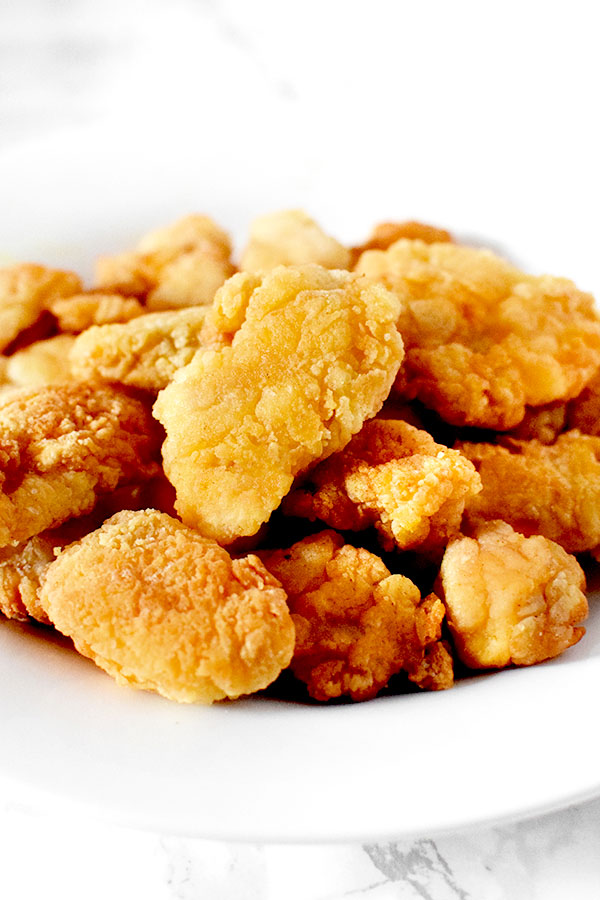 Popcorn chicken piled up on a plate