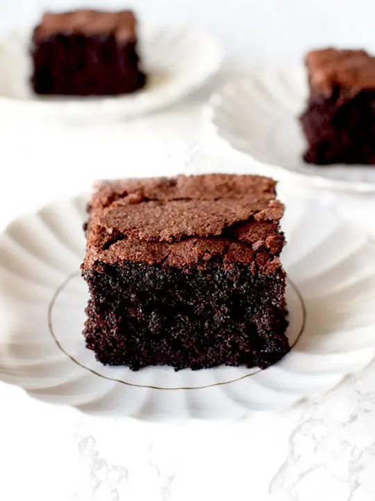 three slices of gluten Free Passover Chocolate Cake on white plates