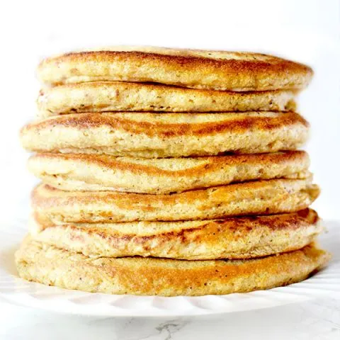 Stack of Passover Pancakes on a white plate sitting on a white marble counter