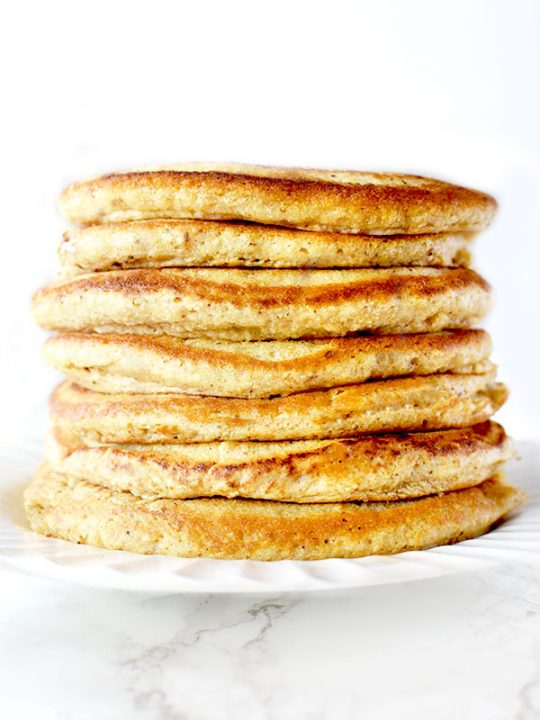 Stack of Passover Pancakes on a white plate sitting on a white marble counter