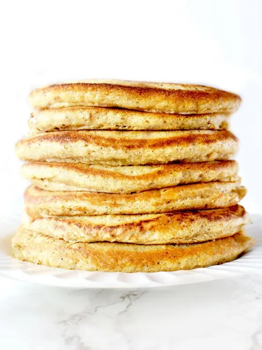Stack of Passover Pancakes on a white plate sitting on a white marble counter
