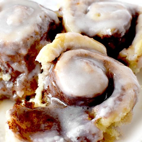 three overnight cinnamon rolls on a white plate