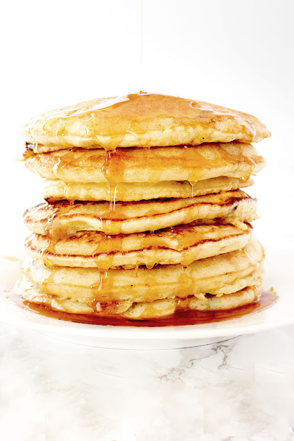 Pancakes with oat milk stacked up on a plate