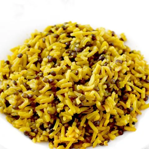 Yellow mujadara piled on a plate