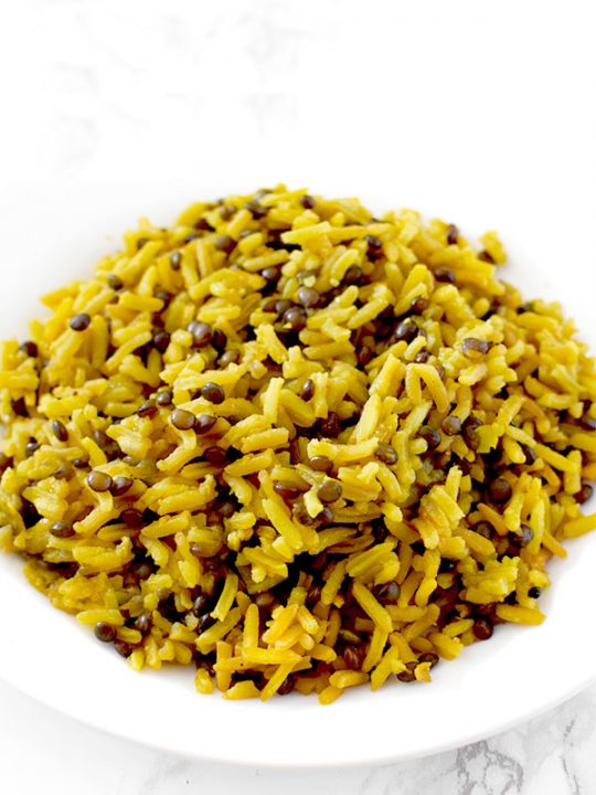 Yellow mujadara piled on a plate