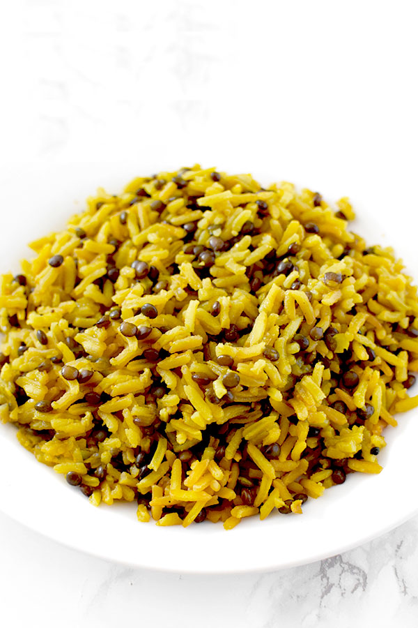 Yellow mujadara piled on a plate