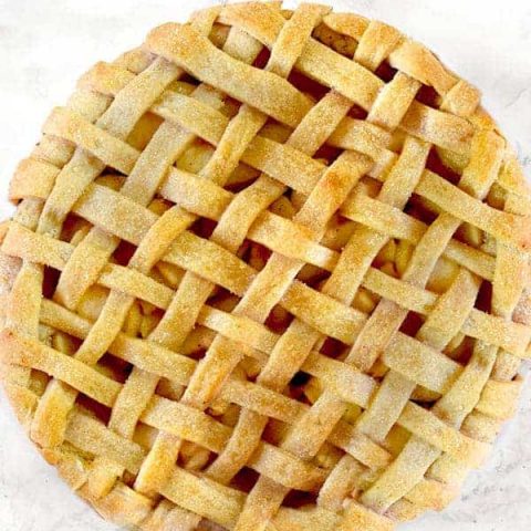 Apple pie on a white marble counter