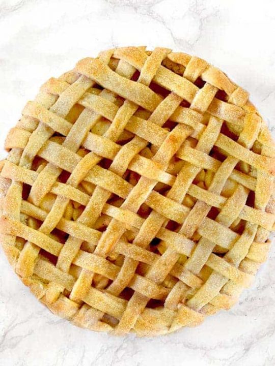 Apple pie on a white marble counter