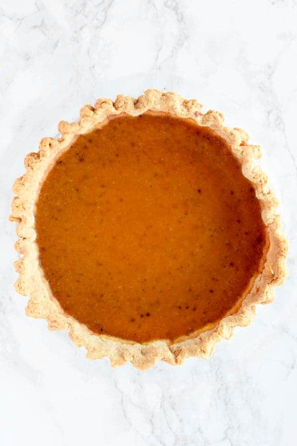 birds eye view of butternut squash pie on a white marble counter