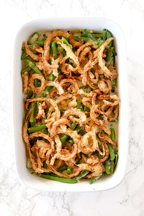 Dairy free green bean casserole with oat milk on a white marble counter