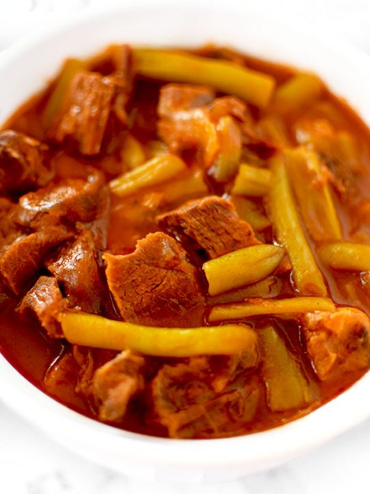 Israeli Beef and Green Beans in a white bowl on a white counter