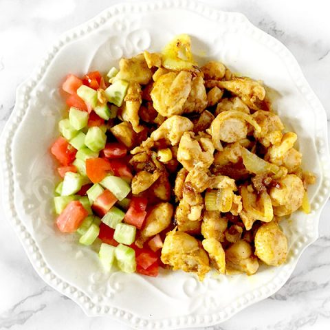 Chicken shawarma on a plate with Israeli salad