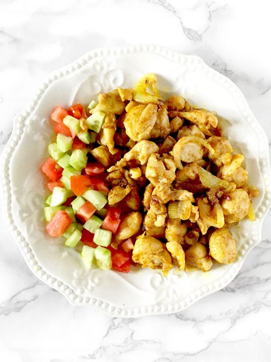 Chicken shawarma on a plate with Israeli salad