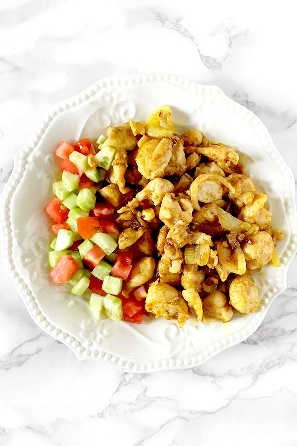 Chicken shawarma on a plate with Israeli salad