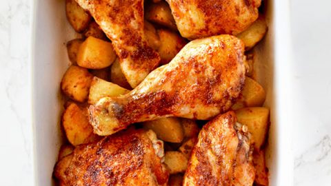 Roasted paprika chicken and potatoes in a white baking dish