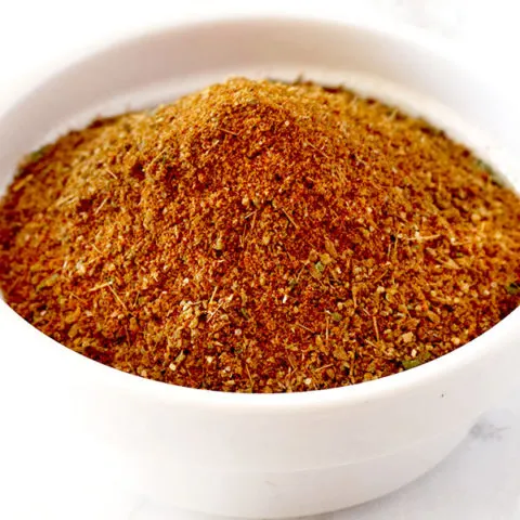 Shawarma seasoning in a white bowl on a white marble counter