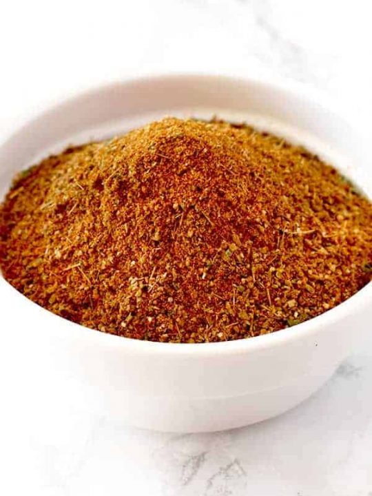 Shawarma seasoning in a white bowl on a white marble counter