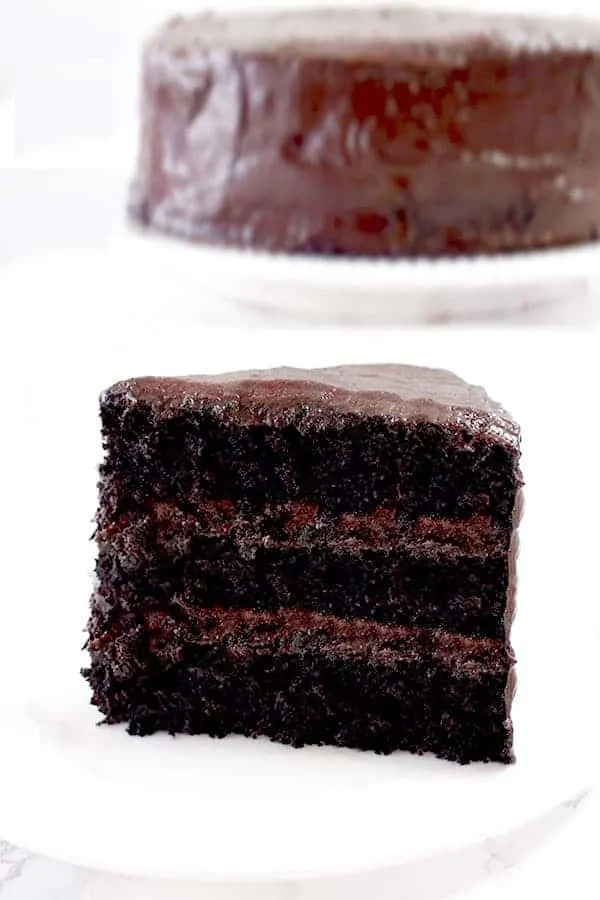 a slice of chocolate cake with a whole chocolate cake in the background