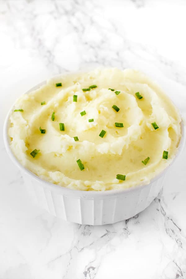 creamy dairy free mashed potatoes in a bowl on a white marble counter